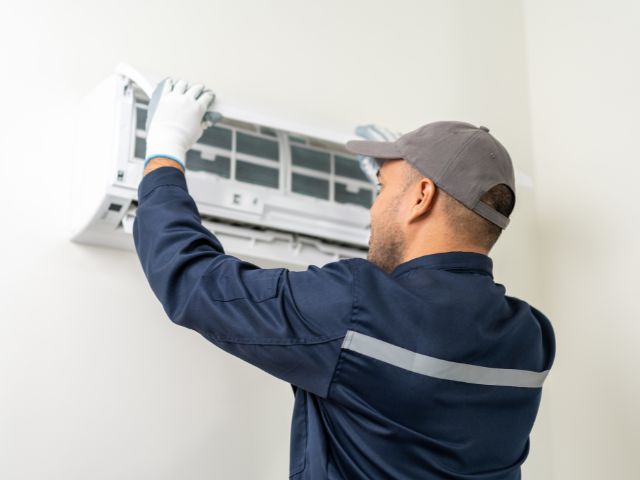 man fixing ac