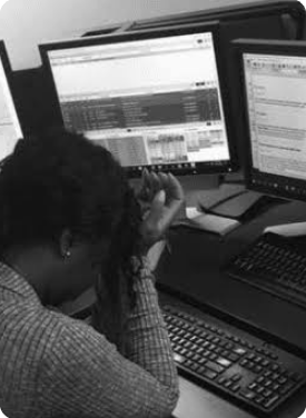 Overloaded Dispatcher Working at Desk